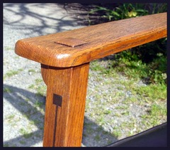 Close-up of the pinned through-tenon construction of the arm and the inlay on the front leg.